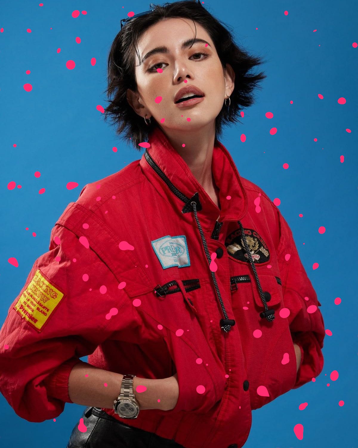 Metaball effect on a portrait of a woman in a red jacket on a blue background, made with the Acid filter in Filter Archive (Spores preset)