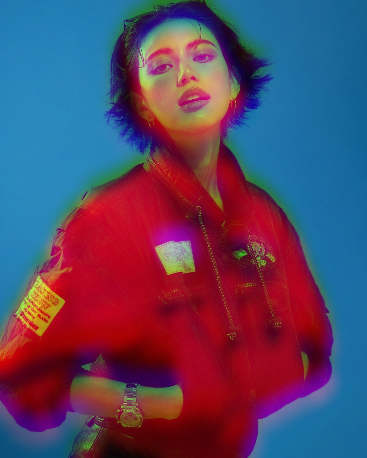 Chromatic aberration effect on a portrait of a woman in a red jacket on a blue background, made with the Chromatic Aberration filter in Filter Archive (Soft Split preset)