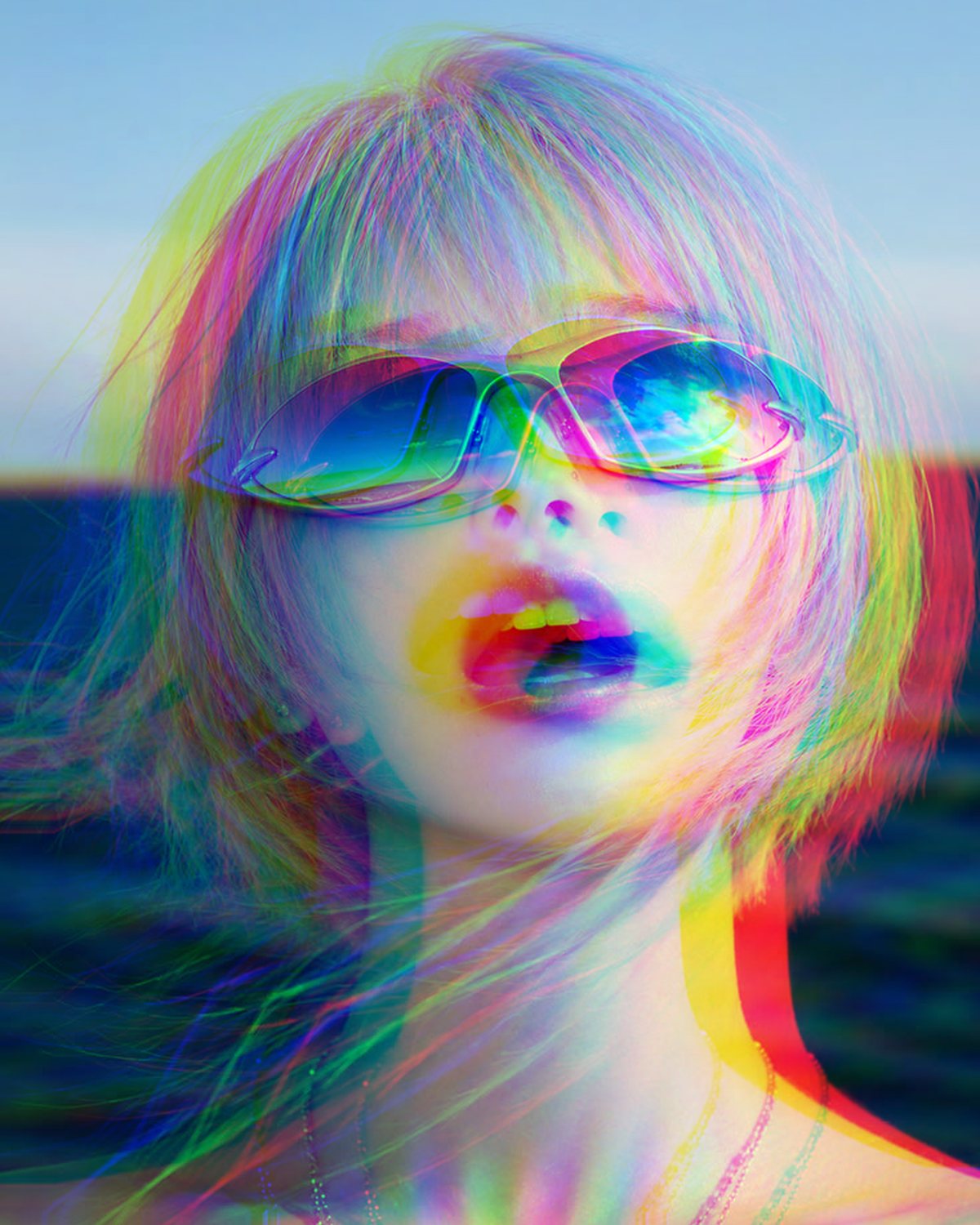 Chromatic aberration effect on a portrait of a woman with silver hair and blue sunglasses by the sea, made with the Chromatic Aberration filter in Filter Archive (Hard Split preset)
