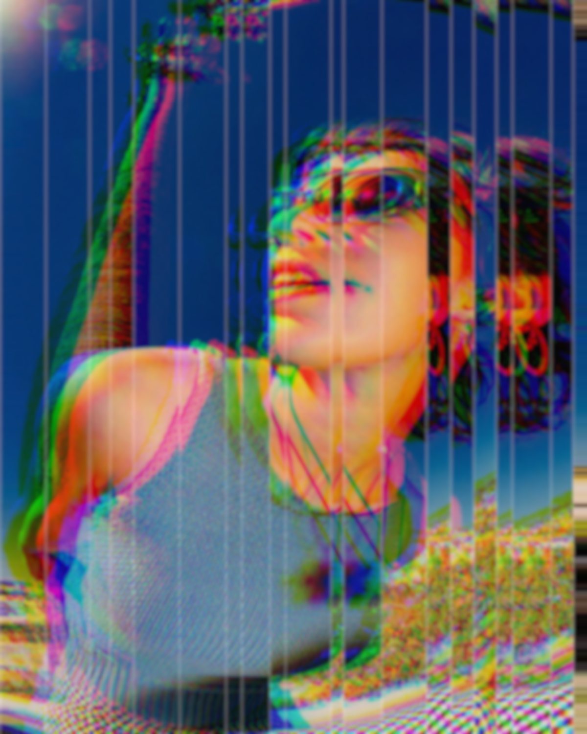 Glass refraction effect on a portrait of a woman in sunglasses against a blue sky, made with the Glass Slice filter in Filter Archive (Shatter preset)