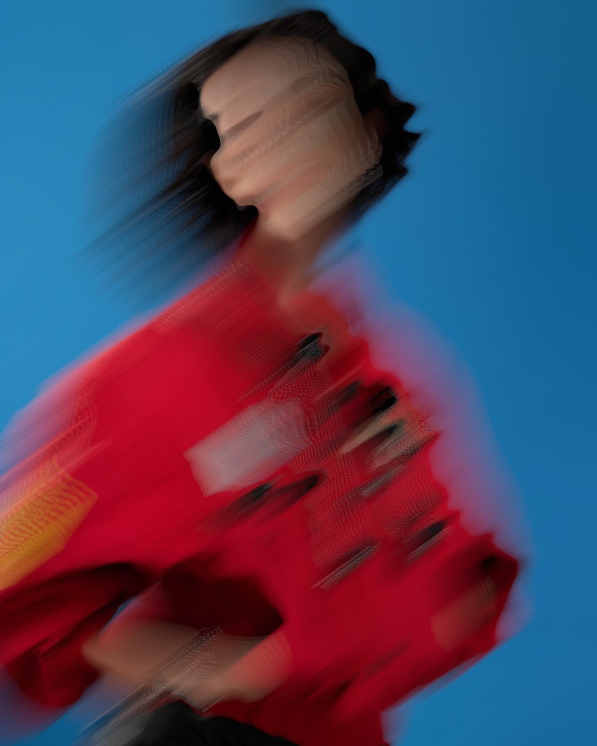 Melt effect on a portrait of a woman in a red jacket on a blue background, made with the Decay filter in Filter Archive (Long Drag preset)
