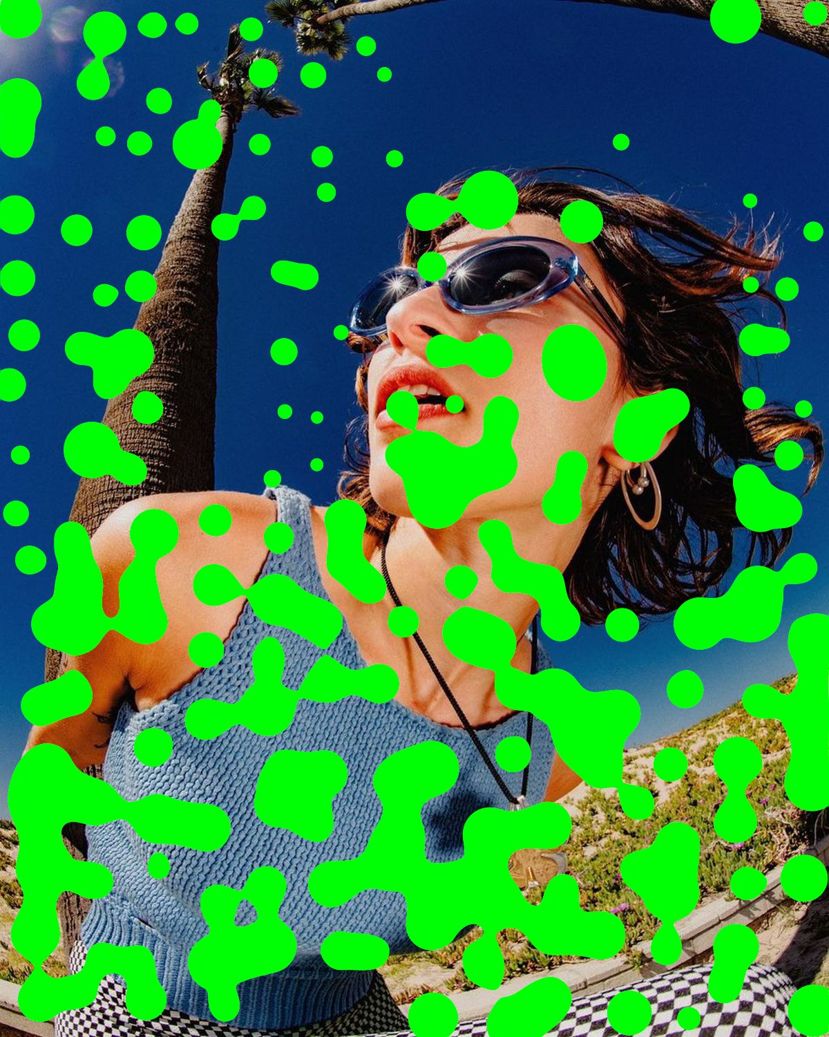 Metaball effect on a portrait of a woman in sunglasses against a blue sky, made with the Acid filter in Filter Archive (Slime preset)