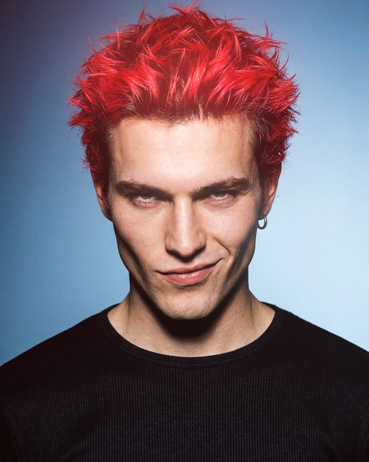 Soft glow effect on a portrait of a man with spiky red hair on a blue background, made with the Glow Up filter in Filter Archive (Neon preset)