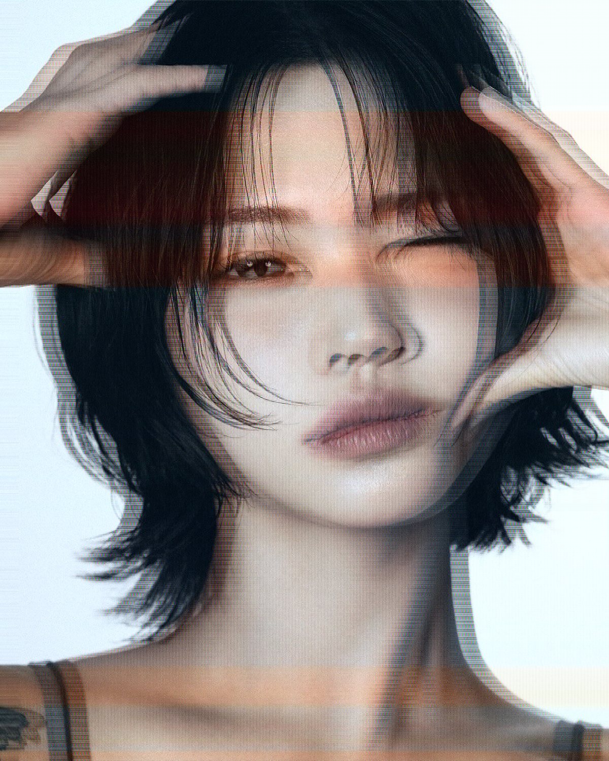 TV glitch effect on a portrait of a woman with black hair, hands on her head, made with the Broadcast filter in Filter Archive (Fast Pan preset)