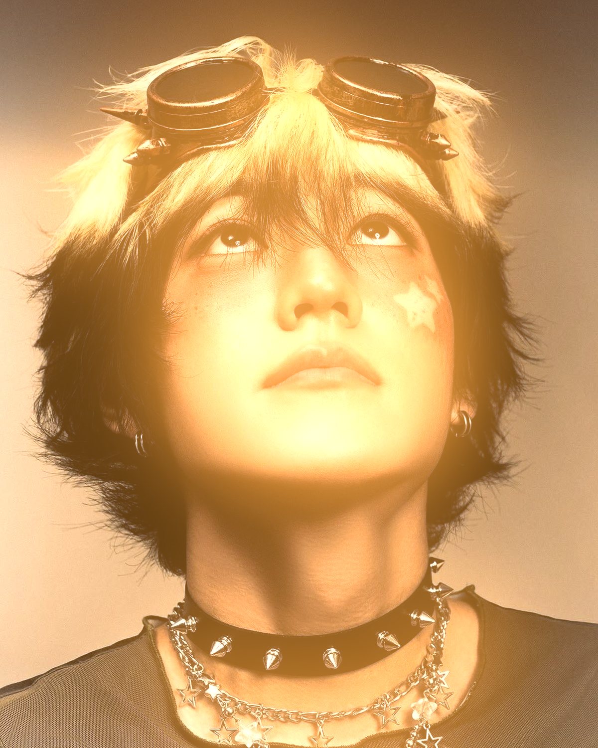 Soft glow effect on a portrait of a person with goggles looking up, made with the Glow Up filter in Filter Archive (Warm preset)